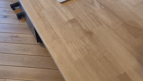 3D Tesla car model on a table with interactive color selection.